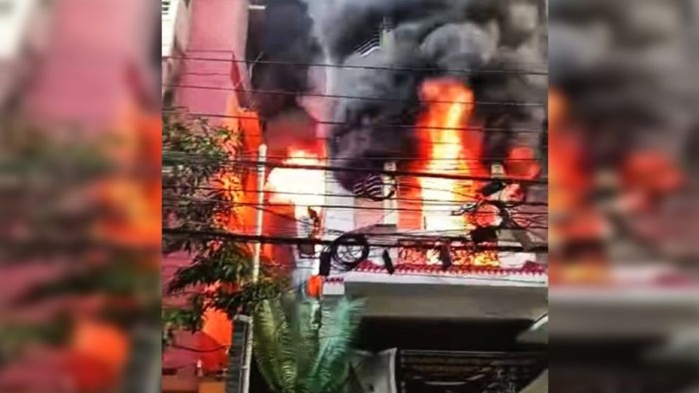 Deadly fire at a seven-storey residential building in Uttara, Dhaka, with firefighters conducting rescue operations.