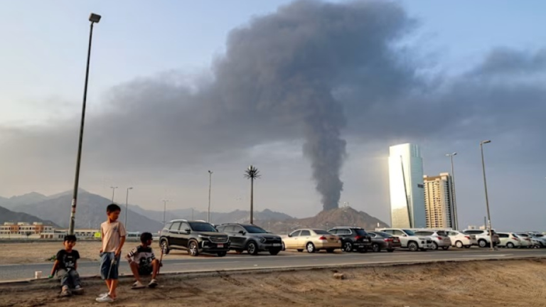 Gulf city skyline at night with missile alert signs, reflecting regional tension and Middle East security concerns